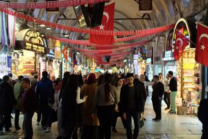 People walking through the Grand Bazaar in Istanbul. One man looks straight into the camera.