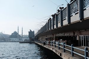 Looking down the Galata Bridge in Istanbul, many fishermen casting rods.